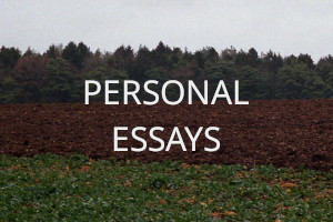 A layered view of a field in the countride from a green border, to a muddy ploughed field, a distant hedge of pine trees, and above a milky sky. Over the image the words 'Personal Essays' are written in uppercase white letters.