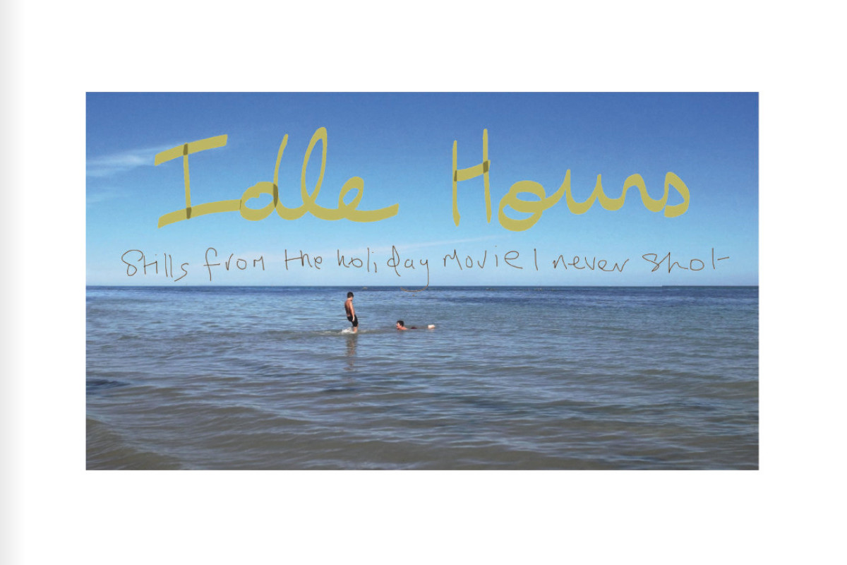 A view of the sea with two children on the water. One if lying down, the other standing. In the sky are the handwritten large words 'Idle Hours'. Below in a smaller script is 'Stills from the holiday movie I never shot'.